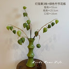 Three forest green lantern fruits + green bamboo vase